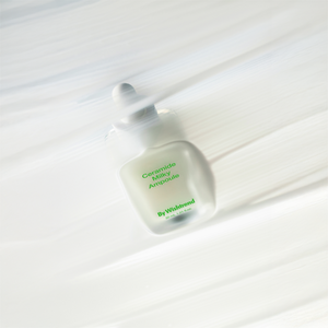 Selenaire By Wishtrend Ceramide Milky Ampoule in a clear bottle with a white pump, highlighting the skincare product.