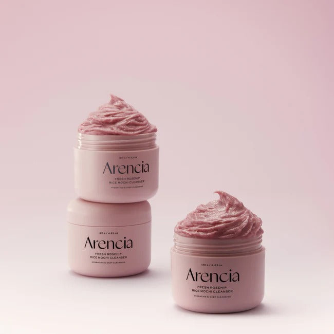 SELENAIRE Arencia Fresh Rosehip Rice Mochi Cleanser with a soft pink container and fresh rosehip ingredients visible.
