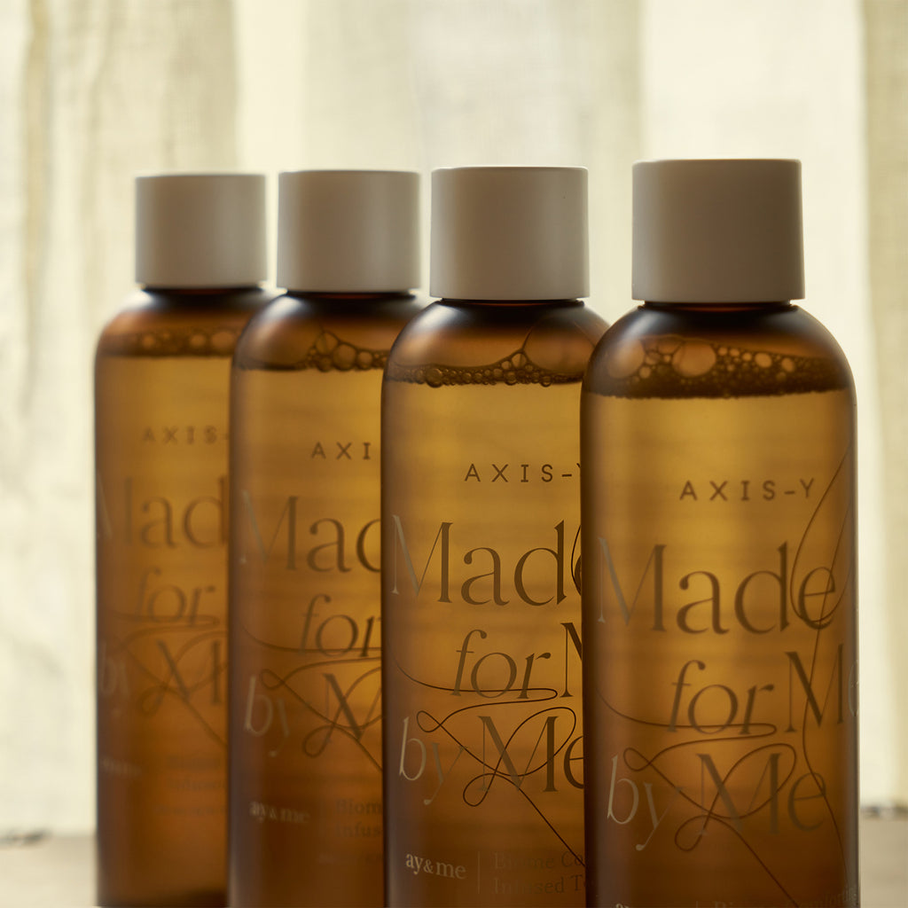 Selenaire AXIS-Y Biome Comforting Infused Toner in a clear bottle with a white cap, showing the product label and liquid inside.