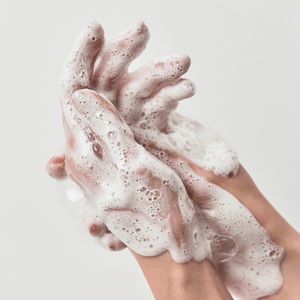 Selenaire Anua Heartleaf Succinic Moisture Cleansing Foam in a white bottle with a pump, featuring heartleaf illustrations.