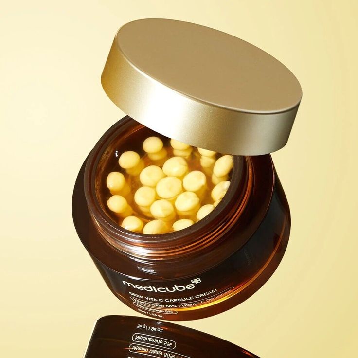 Medicube Deep Vita C Capsule Cream jar with capsules and cream, skincare product for brightening and revitalizing skin.