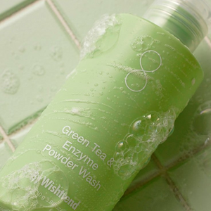 SELENAIRE Green Tea & Enzyme Powder Wash by Wishtrend in jumbo size, showing the powder texture in a clear container.