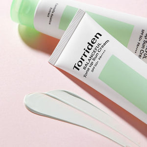 Torriden Balanceful Cica Tone Up Sun Cream in sleek tube, SPF formula, with green tea extract for skincare and sun protection.