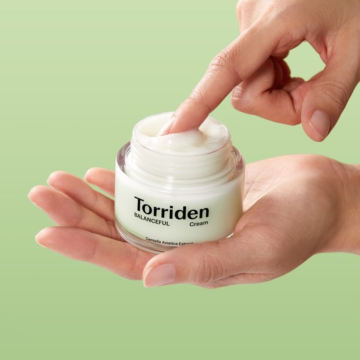 Torriden Balanceful Cica Cream jar with green and white packaging, showcasing the skincare product on a neutral background.