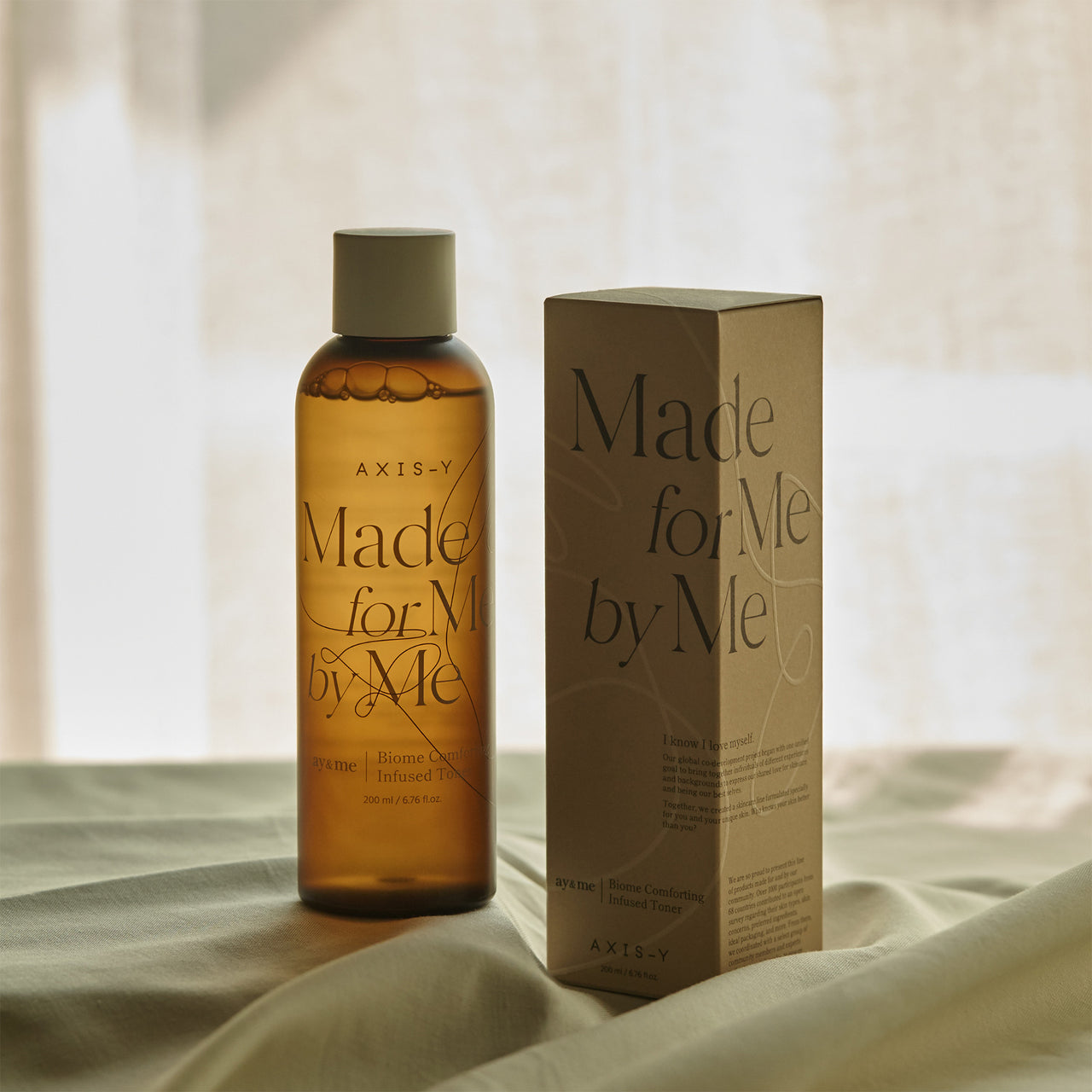 Selenaire AXIS-Y Biome Comforting Infused Toner bottle with label and pump dispenser on a neutral background.